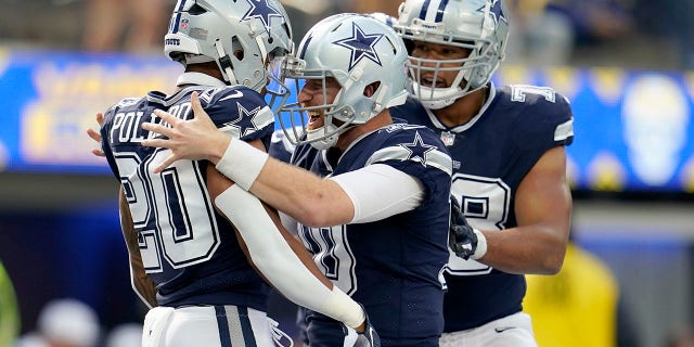 Dallas Cowboys running back Tony Pollard, left, quarterback Cooper Rush, center, and offensive tackle Terence Steele celebrate a touchdown against the Los Angeles Rams, Sunday, Oct. 9, 2022, in Inglewood, California.