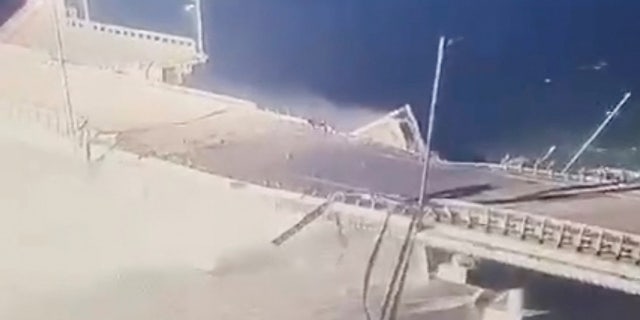 CCTV footage of a collapsed traffic lane is displayed on a monitor, after a freight truck detonated on the strategic road-and-rail Kerch bridge linking Russia and the Crimea peninsula, October 8, 2022 in this video still image obtained by REUTERS