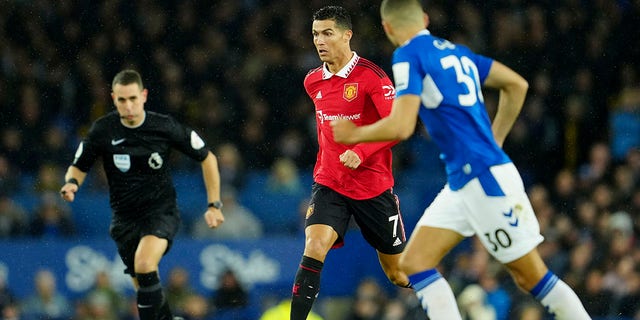 Manchester United's Cristiano Ronaldo runs with the ball during a Premier League soccer game against Everton at Goodison Park, in Liverpool, England, Sunday, Oct. 9, 2022. 