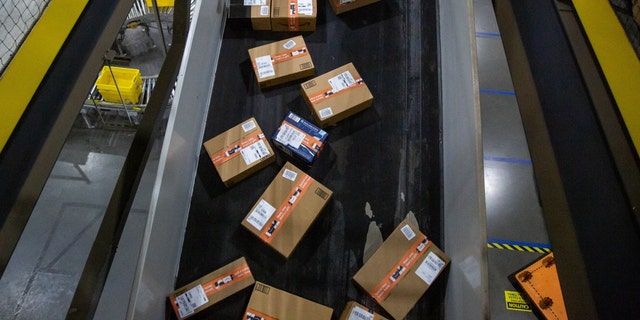 Packages move along a conveyor at an Amazon fulfillment center on Cyber Monday in Robbinsville, N.J., Nov. 29, 2021. 