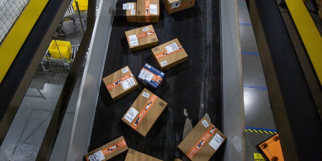 Packages move along a conveyor at an Amazon fulfillment center on Cyber Monday in Robbinsville, N.J., Nov. 29, 2021. 