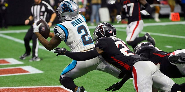 Carolina Panthers wide receiver D.J. Moore (2) catches a touchdown pass as Atlanta Falcons safety Dean Marlowe defends during the second half, Oct. 30, 2022, in Atlanta.