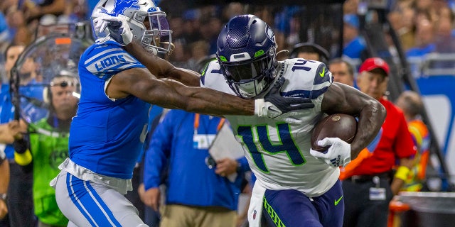 Seattle Seahawks wide receiver DK Metcalf (14) runs with the ball during the second quarter at Ford Field in Detroit on Oct. 2, 2022.