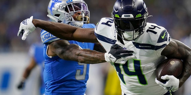 Seattle Seahawks wide receiver DK Metcalf (14) pushes Detroit Lions safety DeShon Elliott during the first half in Detroit on Oct. 2, 2022.