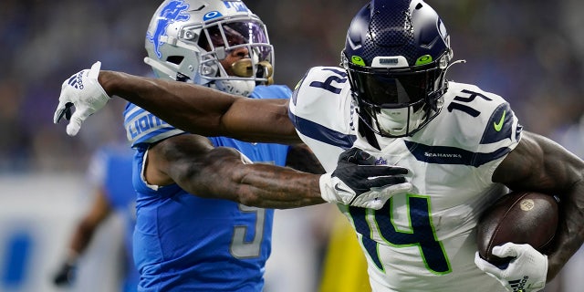 Seattle Seahawks wide receiver DK Metcalf (14) pushes Detroit Lions safety DeShon Elliott during the first half in Detroit on Oct. 2, 2022.
