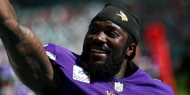 Dalvin Cook, #4 of the Minnesota Vikings, smiles and celebrates with fans after scoring a touchdown during an NFL football game against the Miami Dolphins at Hard Rock Stadium on Oct. 16, 2022 in Miami Gardens, Florida. 