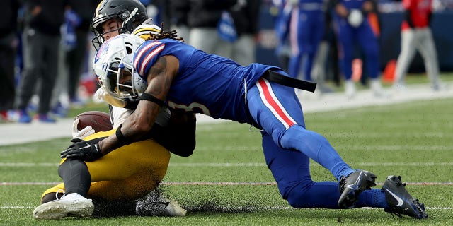Damar Hamlin, right, of the Buffalo Bills tackles Kenny Pickett of the Pittsburgh Steelers during the fourth quarter at Highmark Stadium Oct. 9, 2022, in Orchard Park, N.Y.