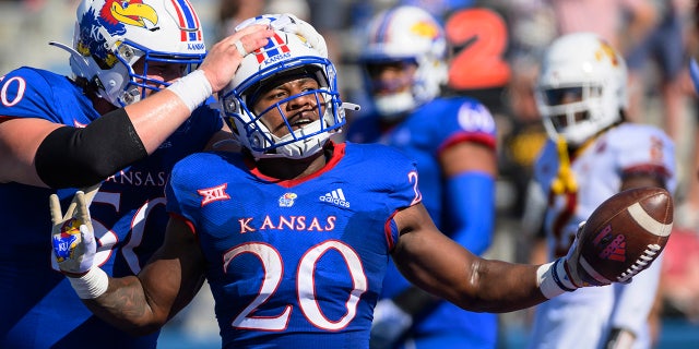 Kansas running back Daniel Hishaw Jr. (20) celebrates with teammate offensive lineman Mike Novitsky (50) after scoring a touchdown against Iowa State during the first half of an NCAA college football game, Saturday, Oct. 1, 2022, in Lawrence, Kan. 