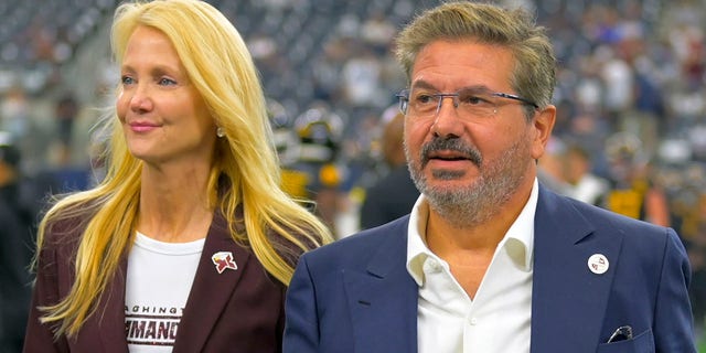 Washington Commanders owners Tanya Snyder, left, and Dan Snyder on the field before the Dallas Cowboys defeat of the Washington Commanders 25-10 at AT&amp;T Stadium on Oct. 2, 2022 in Arlington, TX.