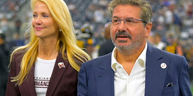 Washington Commanders owners Tanya Snyder, left, and Dan Snyder on the field before the Dallas Cowboys defeat the Washington Commanders 25-10 Oct. 2, 2022, in Arlington, Texas.