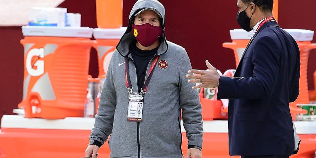 Daniel Snyder, left, talks with team president Jason Wright on the sidelines before the Cincinnati Bengals game at FedExField on Nov. 22, 2020, in Landover, Maryland.