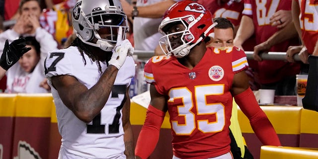 O wide receiver do Las Vegas Raiders, Davante Adams, número 17, comemora a pontuação enquanto o cornerback Jaylen Watson, número 35, do Kansas City Chiefs, assiste durante a segunda metade de um jogo de futebol americano da NFL, segunda-feira, 10 de outubro de 2022, em Kansas City, Missouri.