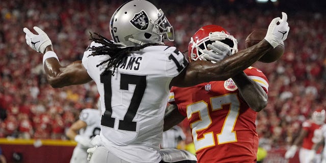 Kansas City Chiefs cornerback Rashad Fenton, #27, breaks up a pass for Las Vegas Raiders wide receiver Davante Adams, #17, in the first half at GEHA Field at Arrowhead Stadium Oct. 10, 2022 in Kansas City, Missouri.