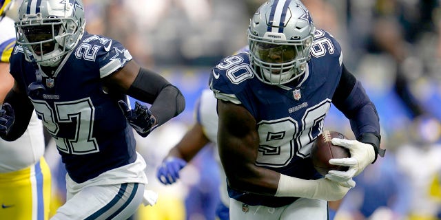 Dallas Cowboys safety Jayron Kearse (27) helps defend as defensive end DeMarcus Lawrence (90) returns a Los Angeles Rams' Matthew Stafford fumble for a touchdown in the first half of an NFL football game, Sunday, Oct. 9, 2022, in Inglewood, Calif.
