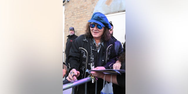Johnny Depp meets his fans before picking up his guitar to play with Jeff Beck.
