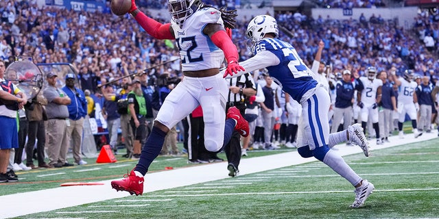 Tennessee Titans running back Derrick Henry leaps past Indianapolis Colts safety Rodney Thomas II for a touchdown in the first half of an NFL football game in Indianapolis, Fla., Sunday, Oct. 2, 2022.