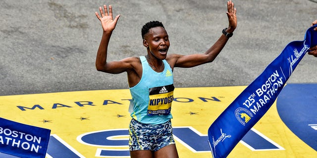 Diana Kipyogei of Kenya crosses the finish line to take first place in the professional women's division during the 125th Boston Marathon in Boston Oct. 11, 2021.