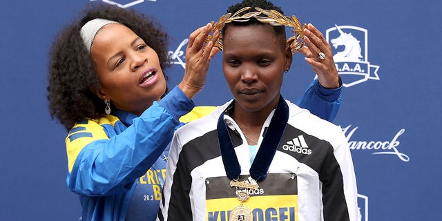 Boston Mayor Kim Janey presents Diana Kipyogei of Kenya with a golden wreath after Kipyogei won the 125th Boston Marathon Oct. 11, 2021 in Boston.