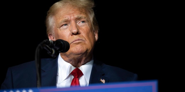 Former President Donald Trump pauses while speaking at a rally at the Minden Tahoe Airport in Minden, Nev., on Oct. 8, 2022. 