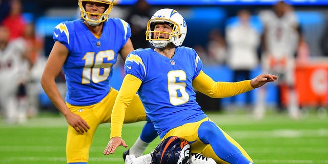 October 17, 2022;  Inglewood, California, USA;  The Los Angeles Chargers field kicker Dustin Hopkins (6) kicks the game-winning goal against the Denver Broncos during overtime at SoFi Stadium.