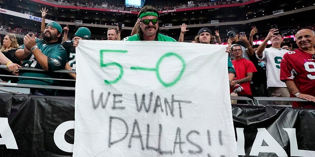 A Philadelphia Eagles fan holds up a sign after the Cardinals game, Sunday, Oct. 9, 2022, in Glendale, Arizona.