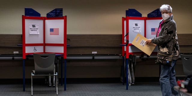 Kathie Hoekstra arrives to vote in Alexandria, Va., Monday, Sept. 26, 2022. In-person voting for the midterm elections has started in Minnesota, South Dakota, Virginia and Wyoming, in a landscape that has changed since the pandemic drove a shift to mail balloting in the 2020 presidential contest. (AP Photo/Andrew Harnik)