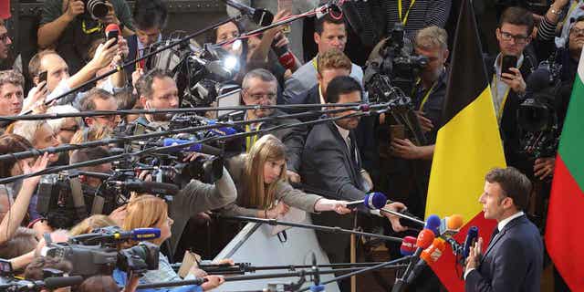 French President Emmanuel Macron speaks to the media as he arrives for an EU summit at the Council of the EU building in Brussels on 20 October 2022. European Union leaders are heading for a two-day summit with conflicting views on the possibility that the blockade could impose a maximum gas price cap to contain the energy crisis.