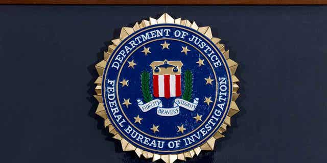 The FBI seal is displayed on a podium before a news conference at the agency's headquarters on June 14, 2018, in Washington. (AP Photo/Jose Luis Magana, File)