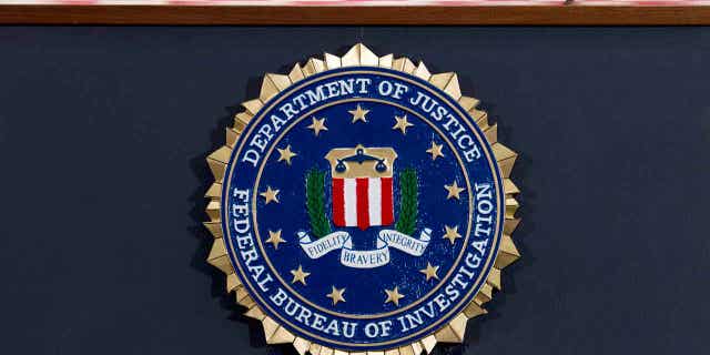 The FBI seal is displayed on a podium before a news conference at the agency's headquarters in Washington. 