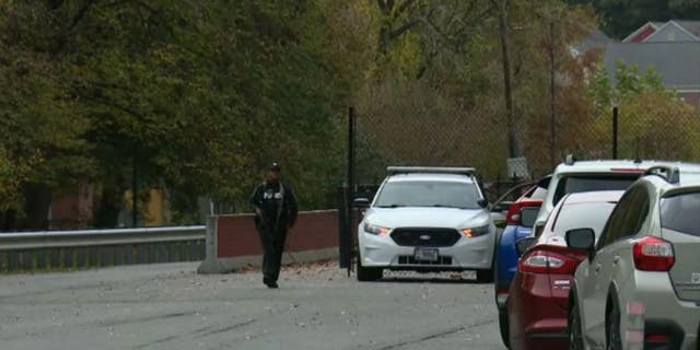 A police officer blocks one entrance to Fort Belvoir, Virginia amid a barricade situation. (Fox News)