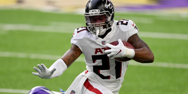 Todd Gurley of the Atlanta Falcons runs with the ball while being tackled by Cameron Dantzler of the Minnesota Vikings at U.S. Bank Stadium Oct. 18, 2020, in Minneapolis.