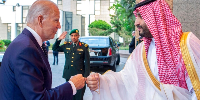 In this image released by the Saudi Royal Palace, Saudi Crown Prince Mohammed bin Salman, right, greets President Joe Biden with a fist bump after his arrival at Al-Salam palace in Jeddah, Saudi Arabia, July 15, 2022.  