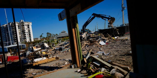 A decorative item recovered from the wreckage of Getaway Marina sits on a table to be saved, as owner Robert Leisure begins the long process of rebuilding his business after the passage of Hurricane Ian, on San Carlos Boulevard in Fort Myers Beach, Fla., Sunday, Oct. 2, 2022.