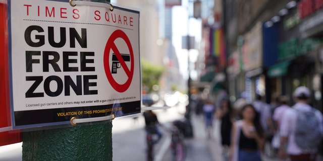 Signs announcing a "gun-free zone" were posted at every entry and exit point of the Times Square area as a New York law limiting where firearms can be legally carried in public is set to go into effect on Thursday.