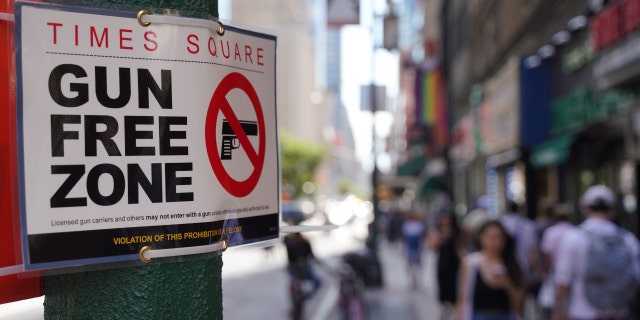 Signs announcing a "gun free zone" were posted at every entry and exit point of the Times Square area of New York City as a New York law limiting where firearms can be legally carried in public was set to go into effect in September.