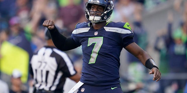 Seattle Seahawks quarterback Geno Smith, #7, celebrates a touchdown run by running back Kenneth Walker III during the second half of an NFL football game against the Arizona Cardinals in Seattle, Sunday, Oct. 16, 2022. 