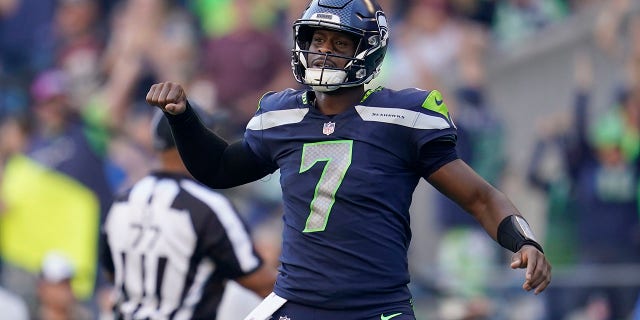 Seattle Seahawks quarterback Geno Smith, #7, celebrates a touchdown run by running back Kenneth Walker III during the second half of an NFL football game against the Arizona Cardinals in Seattle, Sunday, Oct. 16, 2022. 