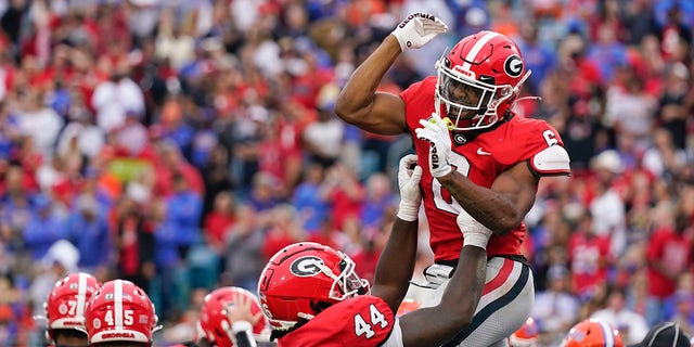 Georgia running back Kenny McIntosh, right, celebrates with teammate tight end Cade Brock (44) after scoring a touchdown against Florida during the first half of an NCAA college football game Saturday, Oct. 29, 2022, in Jacksonville, Fla.