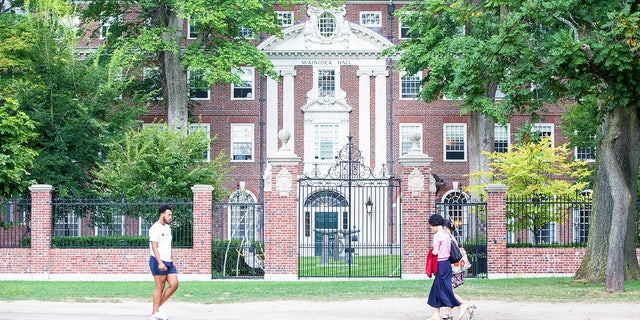Pedestrians walk past a Harvard University building on August 30, 2018 in Cambridge, Massachusetts. The U.S. Justice Department sided with Asian-Americans suing Harvard over admissions policy. 