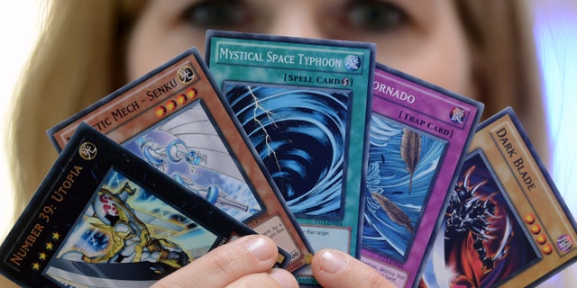 A participant presents a bunch of Yu-Gi-Oh cards at the German Yu-Gi-Oh! Trading Card Game Championships in Schkeuditz, Germany, 18 May 2013. More than 800 players competed against each other to win the title of German champion of the Japanese card game. The best 32 players achieved a qualification for the European Championships at the end of June i n Frankfurt (Main). Photo: Hendrik Schmidt/dpa | usage worldwide (Photo by Hendrik Schmidt/picture alliance via Getty Images)
