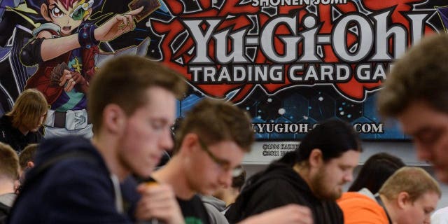 FILE - Participants of the German Yu-Gi-Oh! Trading Card Game Championships play against each other in Schkeuditz, Germany, May 18, 2013.