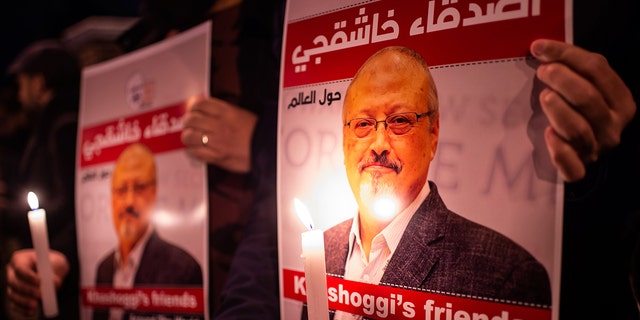 People hold posters picturing Saudi journalist Jamal Khashoggi and lightened candles during a gathering outside the Saudi Arabia consulate in Istanbul, on October 25, 2018. - Jamal Khashoggi, a Washington Post contributor, was killed on October 2, 2018 after a visit to the Saudi consulate in Istanbul to obtain paperwork before marrying his Turkish fiancee. 