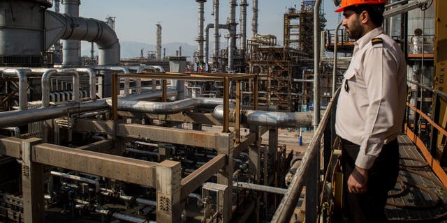 A security guard stands at his station at the Persian Gulf Star Co. gas condensate refinery in Bandar Abbas, Iran. (Ali Mohammadi/Bloomberg via Getty Images)