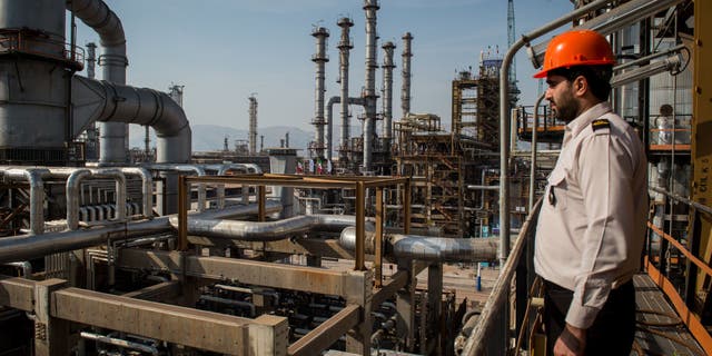 A security guard stands at his station at the Persia Gulf Star Co. gas condensate refinery in Bandar Abbas, Iran.  (Ali Mohammadi / Bloomberg via Getty Images)