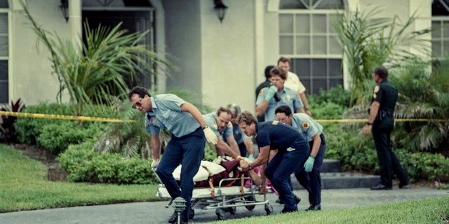 Paramedics take Marlene Warren to an ambulance on May 26, 1990, after she was shot in front of her home in Wellington, Fla. 