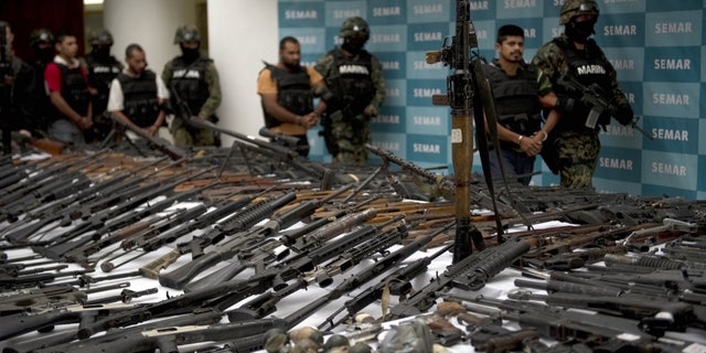 Mexican Marines escort five suspected drug traffickers from the Zeta drug cartel in front of an RPG-7 rocket launcher, hand grenades, firearms, cocaine and military uniforms seized from suspected members of the Zetas drug cartel and presented to the press on the 9th. June 2011 at the Secretariat of the Navy in Mexico City.  Five men were arrested and more than 200 rifles, eleven pistols, military uniforms, ammunition of various calibers and more than 200 kg of cocaine were seized by the navy in the states of Coahuila and Nuevo Leon.