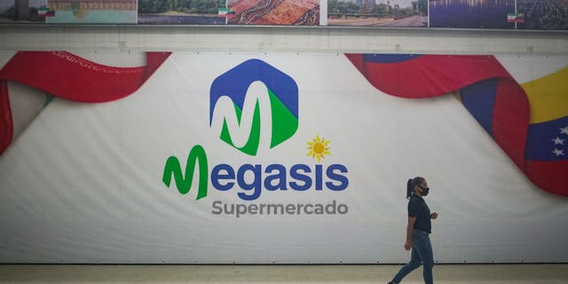 A woman goes to the Iranian supermarket "Megasis" after its opening July, 30, 2020, in Caracas, Venezuela. "Iran, as well as every country in the world, has a right to free trade," said Iran's ambassador to Caracas at the opening. Tehran had recently sent five tankers full of gasoline to Venezuela.