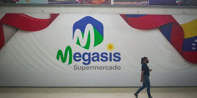 A woman goes to the Iranian supermarket "Megasi" after its opening on July 30, 2020 in Caracas, Venezuela. "Iran, like every country in the world, has the right to free trade," the Iranian ambassador to Caracas said at the opening.  Tehran had recently sent five tankers full of gasoline to Venezuela.