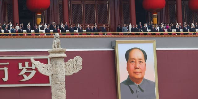 Chinese President Xi Jinping (C), standing with former President Hu Jintao, attends the celebration marking the 100th anniversary of the founding of the Chinese Communist Party on July 1, 2021 in Beijing. 