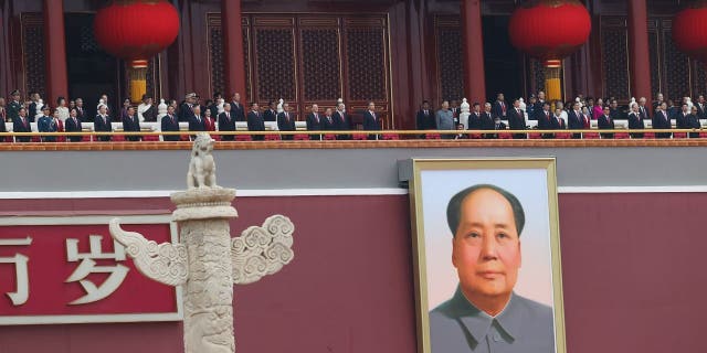 Chinese President Xi Jinping (C), standing with former President Hu Jintao, attends the celebration marking the 100th anniversary of the founding of the Chinese Communist Party on July 1, 2021 in Beijing.